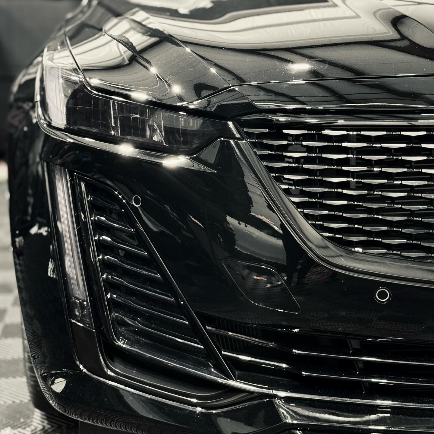 Background of a Cadillac CT5 with a Chrome Delete job applied by Wrap Daddy's