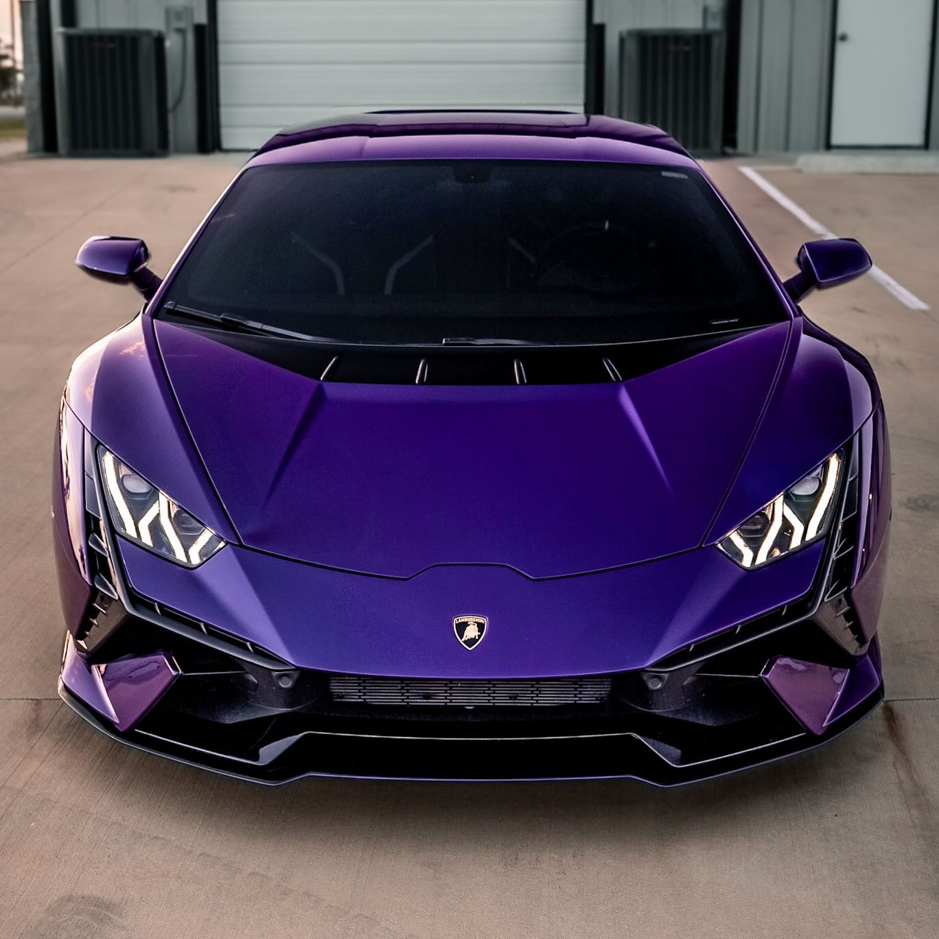 Background of a Lamborghini Tecnica in stunning Viola Pasifae, the rarest color Lamborghini has ever produced, preserved without alteration. Wrapped in full-body XPEL Ultimate Plus PPF installed edge-to-edge, then ceramic coated for added gloss, hydrophobic protection, and longevity. Carbon fiber trim and red calipers left exposed. All services provided by Wrap Daddy's